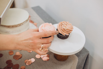 Birthday cake. Garland - happy birthday, hanging on the wall. Candy bar with cake, marshmallows, and cupcakes. Stylish decor for a children's party.