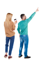 Back view of couple in sweater pointing.