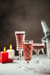 Two glasses of  champagne on dark wooden background. Festive drink. Valentins or Christmas concept.