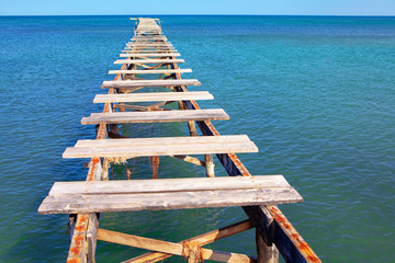 broken wooden harbour to open sea 