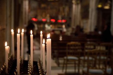 Burning candles in church, shallow depth of field