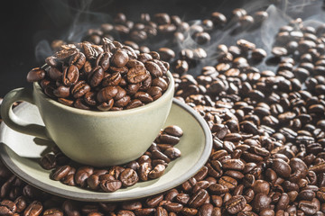 Coffee cup and coffee beans on table background. Top view with copy space for your text