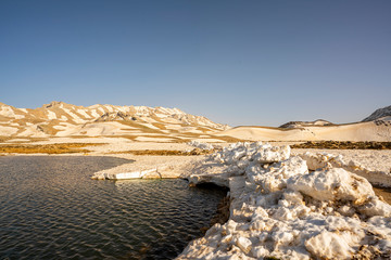 Lake Egrigol (eğrigöl), a hidden gem sitting at 2,350 meters in the foothills of Geyik Mountain in Antalya province, Surrounded by 3 or 4 meters of snow on one side and mountain wild flowers