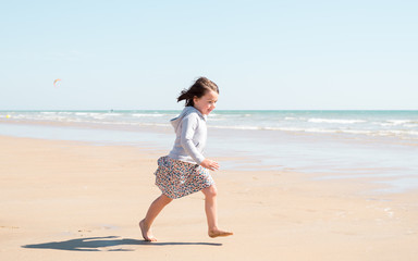 Young girl enjoying the beach on a beautiful sunny day