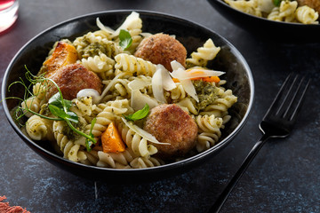 Pasta with meatballs and homemade parsley pesto sauce. Copy space.