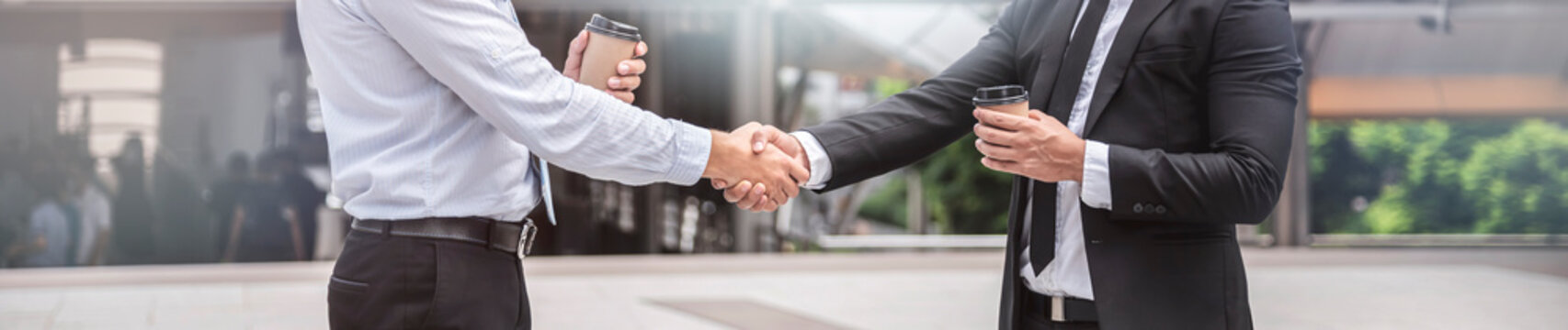 Businessmen handshake in the city, congratulation, cooperation, successful, panoramic banner