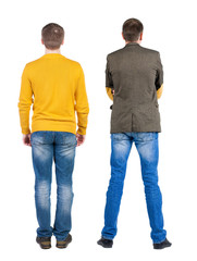 Back view of two man in sweater pointing.