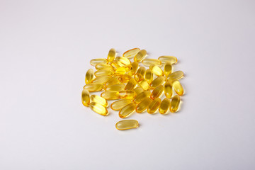 Many omega 3 capsules are isolated on a white background