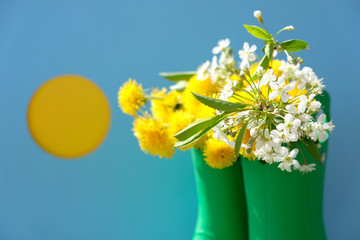 Rubber boots with flowers on blue background