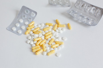 colored pills, the empty  blisters of colorful pills on white background