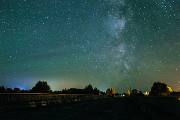 amazing panorama of the stars of the night sky with the Milky Way over the village. starry sky. night shooting