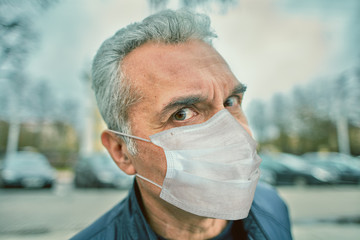 Caucasian man in disposable facial mask.