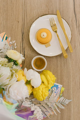 
Mousse cake, a cup of espresso and a bouquet of flowers. Flat lay. Beautiful composition with dessert. Concept of coffee shop and flower shop.