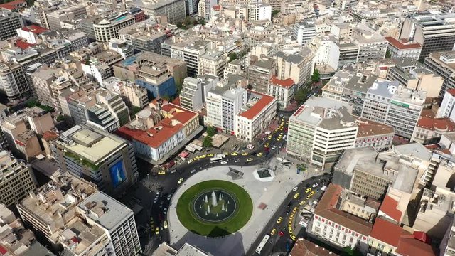 Aerial 4k video of recently renovated fountain of famous round square of Omonia, Athens centre, Attica, Greece