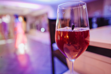 Banquet. Cover the table with a white tablecloth. On the table is glass of wine, dishes with food. A fly in a glass