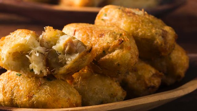Slide shot Brazilian snack cod fish fried with smoke. Beef Croquettes on the table.