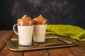 Two glasses with trendy coffee Dalgona made by whipping instant coffee with water and sugar