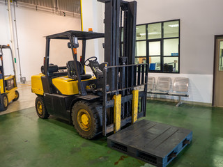 Forklift loader. Pallet stacker truck equipment at warehouse.
