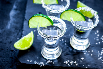 Set for tequila party with lime and salt on black background