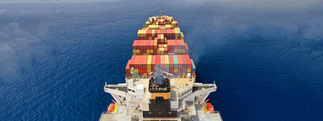 Aerial drone panoramic ultra wide photo of industrial container tanker ship cruising in open ocean...