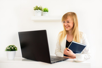 Female lawyer giving a consultation online at home. Young girl student at a laptop. Online counseling, online education, distance learning. Tax advice to lawyer or accountant.