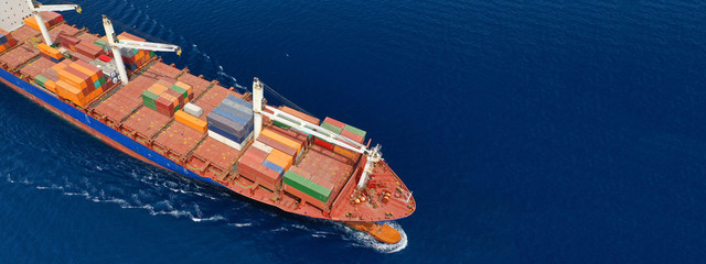 Aerial drone panoramic ultra wide photo of industrial container tanker ship cruising in open ocean...
