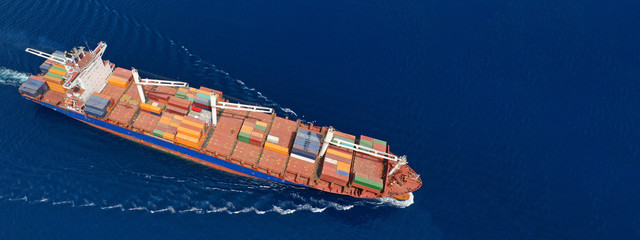 Aerial drone panoramic ultra wide photo of industrial container tanker ship cruising in open ocean...