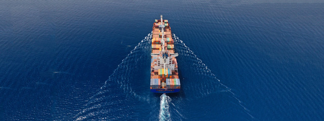 Aerial drone panoramic ultra wide photo of industrial container tanker ship cruising in open ocean...