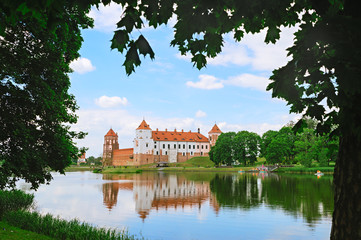 Naklejka na ściany i meble Beautiful view of Mir Castle. Castle reflection in lake water