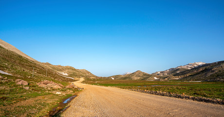 Lake Egrigol (eğrigöl), a hidden gem sitting at 2,350 meters in the foothills of Geyik Mountain in Antalya province, Surrounded by 3 or 4 meters of snow on one side and mountain wild flowers