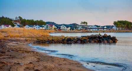 Sandy beach with houses in the horizon.