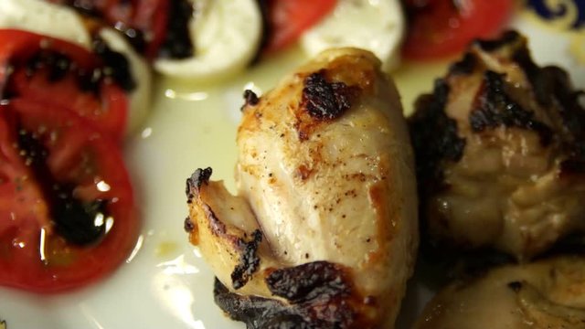 chicken legs baked in honey, and tomatoes with mozzarella drenched in balsamic sauce