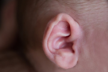 Ear of a newborn close-up. Children's hearing.