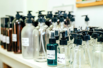 Different sizes pumping and spray bottles, recycling materials in a shop. Zero waste concept.