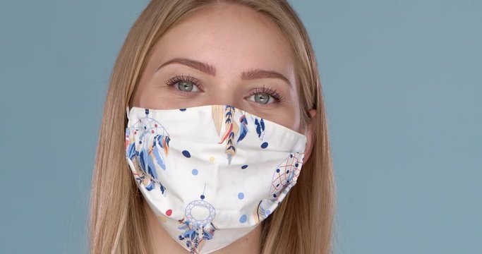 Beautiful woman wearing stylish face mask. Protection against viruses, pollution and dust