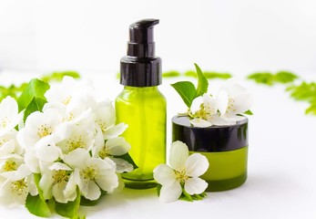 Natural, natural cosmetics. A glass bottle with a dispenser and a jar for cream. Close up. Front view