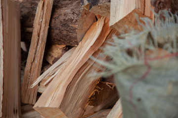 Trees in the sawmill are stacked in bags for sell. Stacks of firewood. Preparation of firewood for the winter. A heap of woodpile. Chopped wood. Firewood.Pile of wood logs ready for winter
