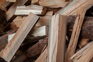 Trees in the sawmill are stacked in bags for sell. Stacks of firewood. Preparation of firewood for the winter. A heap of woodpile. Chopped wood. Firewood.Pile of wood logs ready for winter
