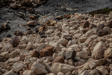 Cobblestones outdoors texture. Broken fireplaces in the street.Concrete road broken in. It is not standard
