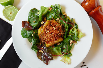 Salad with caramelized liver and couscous. Salad mix, caramelized chicken liver with apples, couscous, raspberry sauce, potato pie, walnut