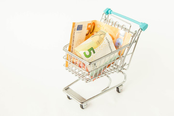 Small trolley with euro. Coronavirus crisis money stimulus policy, QE or money injection to aid economics and business to survive in COVID-19 outbreak
