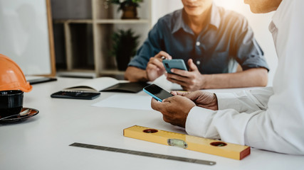 Group of architect engineer interior designer meeting and discussing about work in progress at construction office.