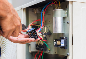 Close up of Air Conditioning Repair, repairman installing magnetic contactor and fixing air...