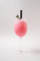 Making cocktails at home like an expert nightclub barman. Fresh and juicy colorful homemade cocktails garnished with berries, orange, mint and coffee on white background.