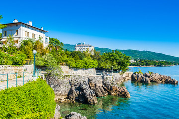 Fototapeta na wymiar Beautiful Adriatic sea in Croatia, town of Lovran riviera, coastline villas in Kvarner bay