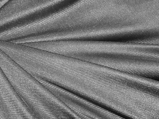 Folds of dark silver fabric texture background