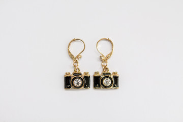 gold earrings camera on a white background