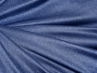 Naklejka premium Folds of blue fabric texture background