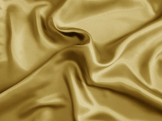 Gold shiny fabric. Wavy background