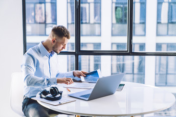 Focused businessman reviewing report at work